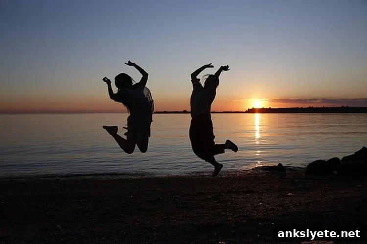 Two young people jumping up and down