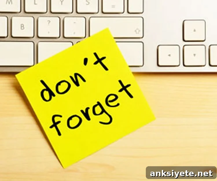 A post-it note on a keyboard illustrating a reminder cue.