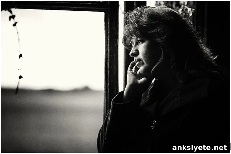 Image shows a contemplative woman