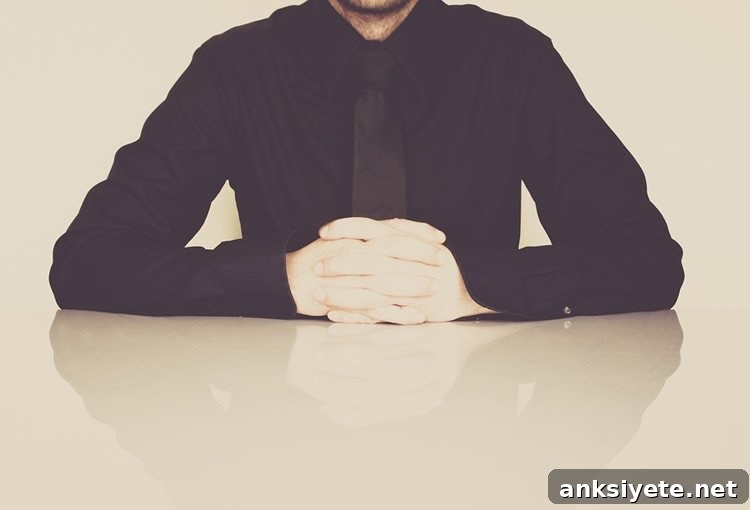 Image shows a man sitting at a desk.