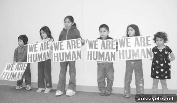kids holding we are human signs