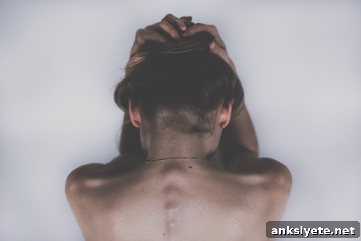 A woman holding her head, illustrating fibromyalgia symptoms