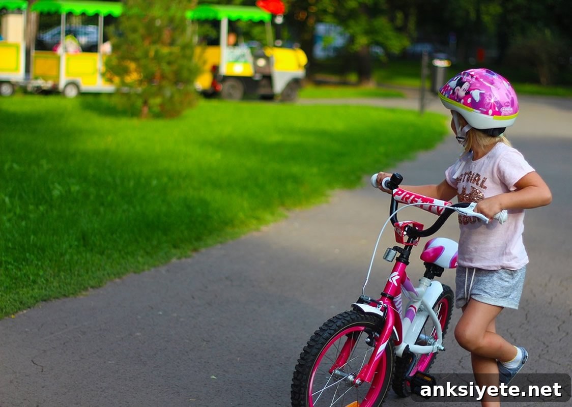 This shows a young girl on a bike
