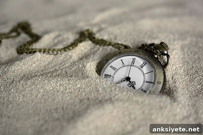 This shows a pocket watch in the sand