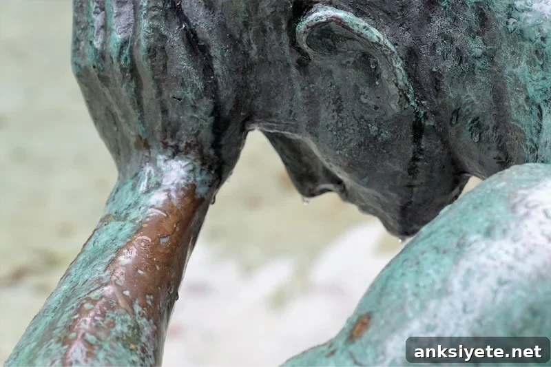This is a statue of a man holding his head