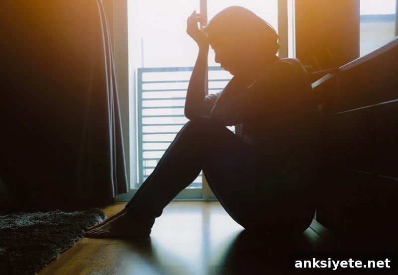 Long-Term PTSD After Miscarriage or Ectopic Pregnancy 2 This shows a woman sitting in the dark