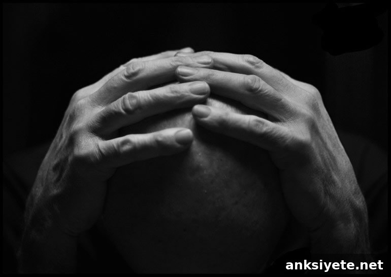 This shows a man holding his head