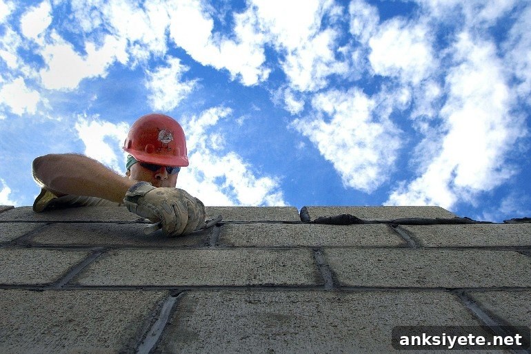 This shows a man building a wall