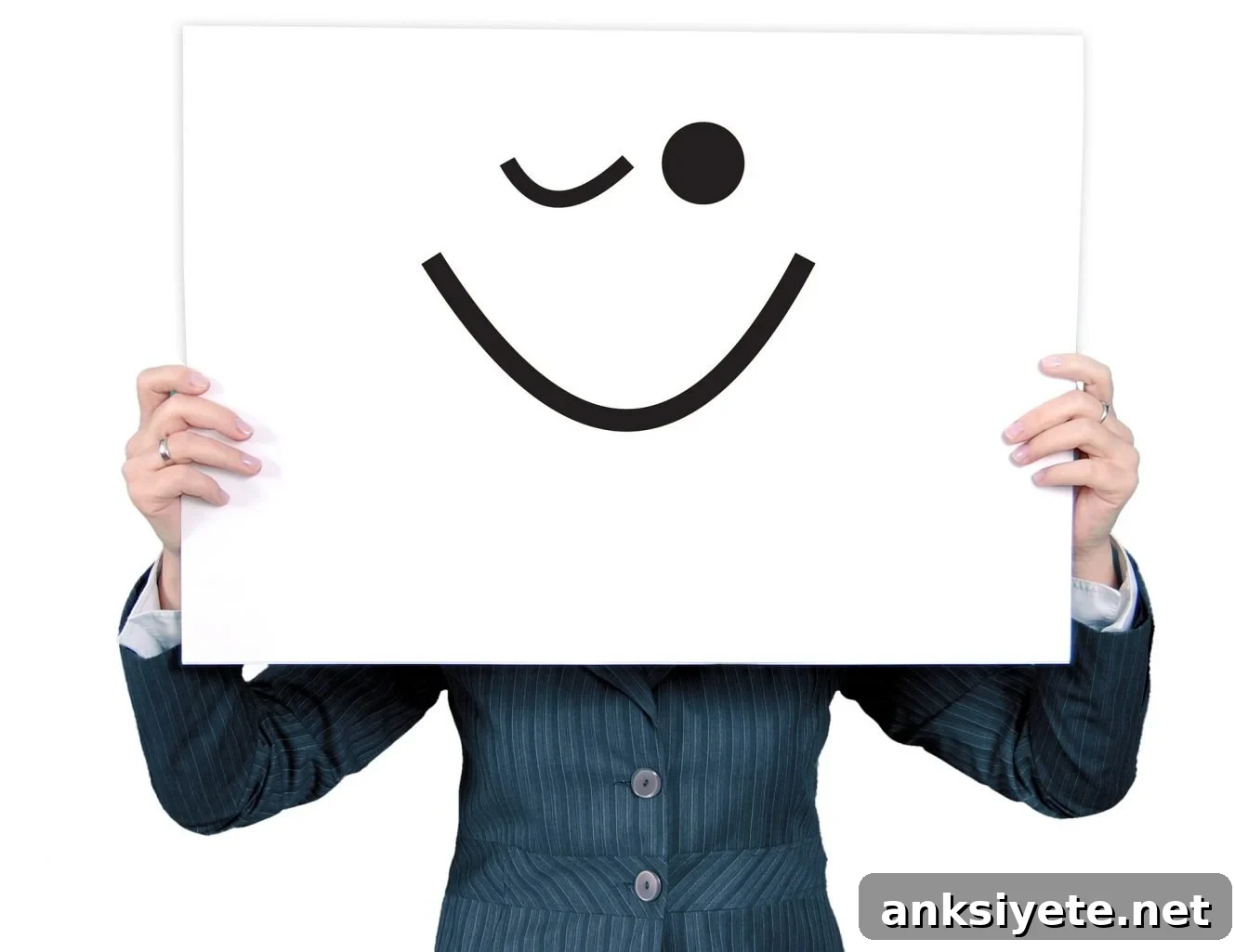 This shows a man holding up a sign with a blinking face drawn on it