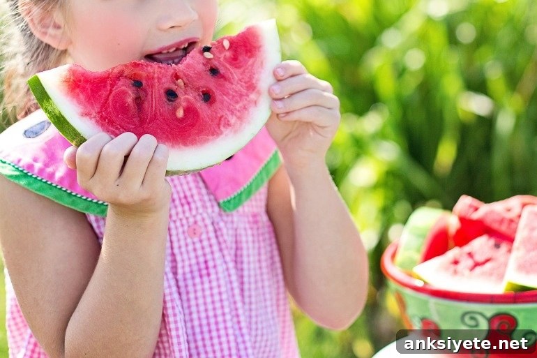This shows a little girl lifting a piece of watermelon to her lips