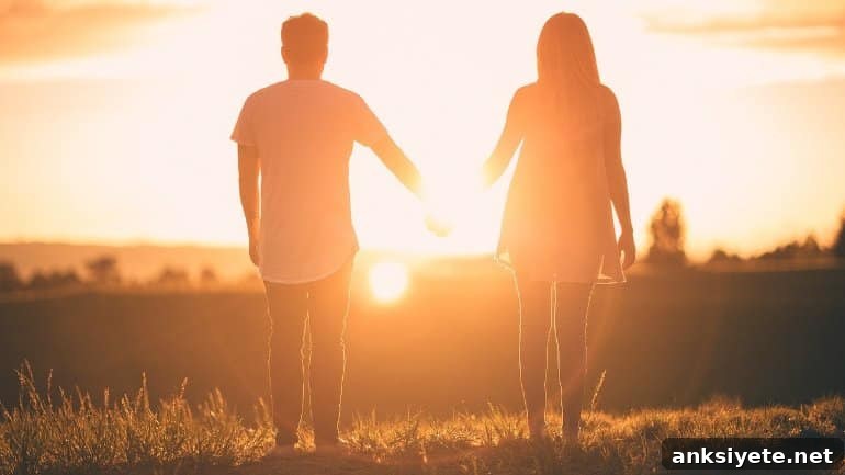 This shows a couple holding hands in the sunset