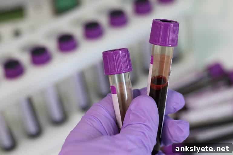 This shows a hand holding up blood in test tubes