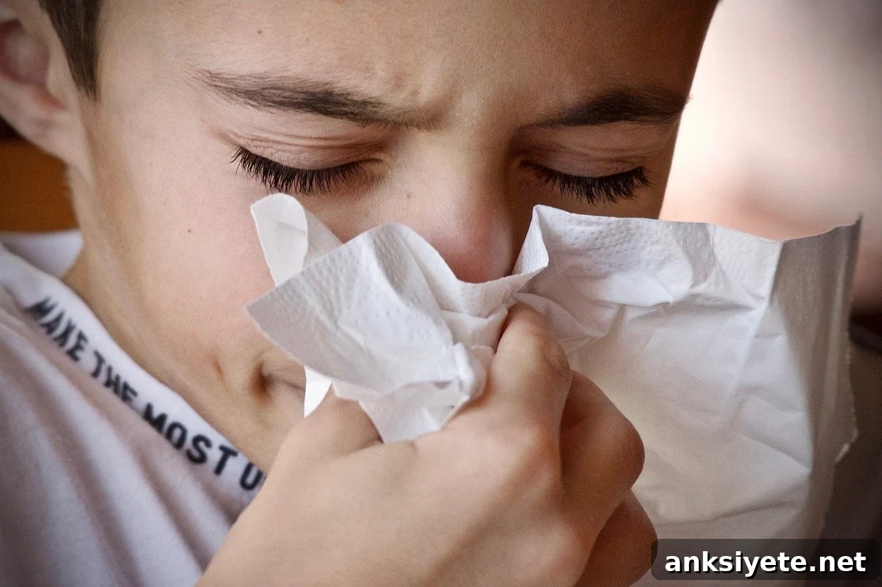 This shows a boy sneezing into a tissue