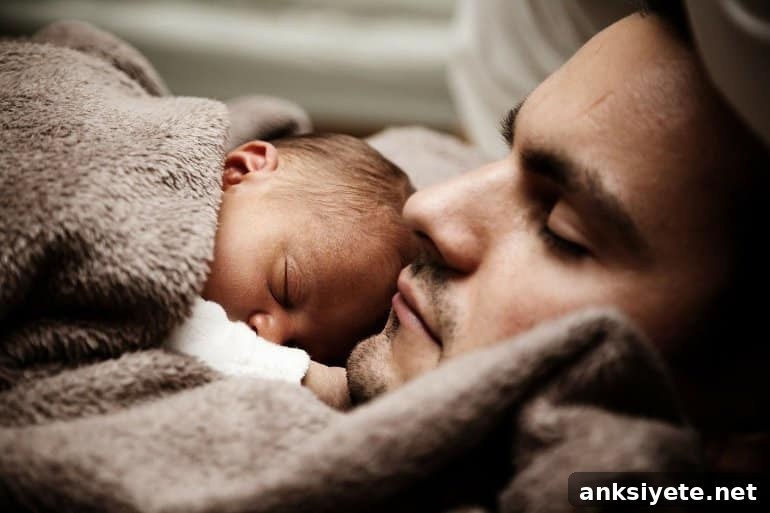 This shows a dad and baby sleeping