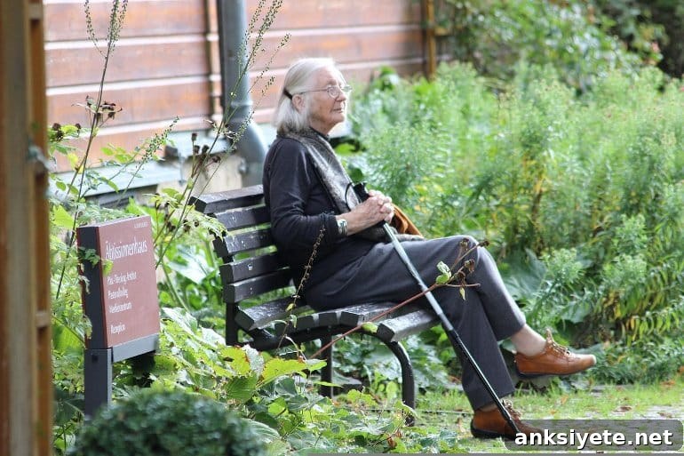 This shows an older woman sitting on a park bench