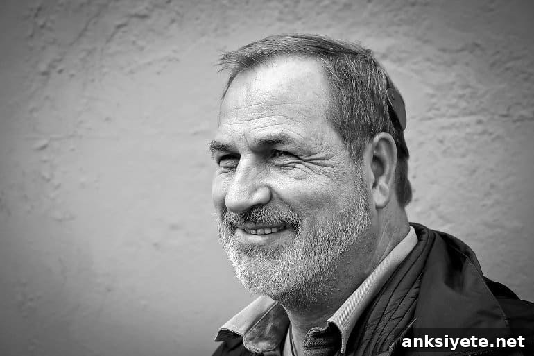 This shows an older man with a hearing aid