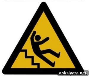 The image shows a caution sign with a person falling down stairs.